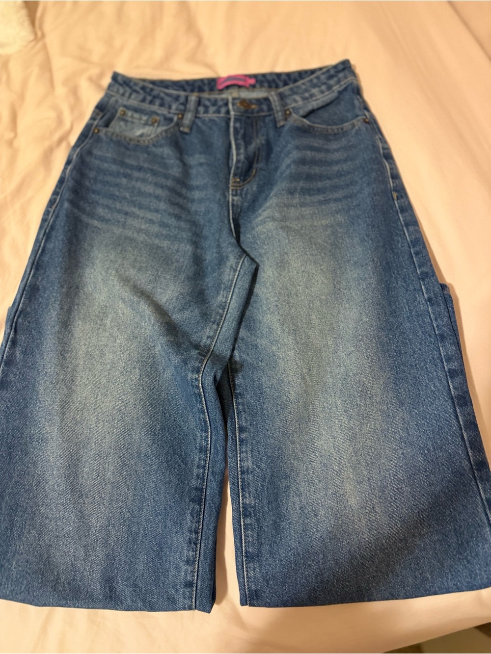 Dark wash womens jeans with NYC embroidered on the back